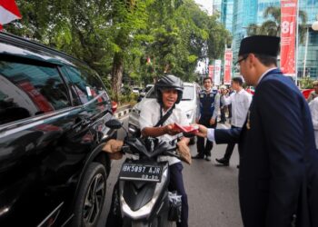 Kibarkan Semangat Kemerdekaan, Rico Waas dan Zakiyuddin Harahap Bagikan Bendera kepada Warga Medan
